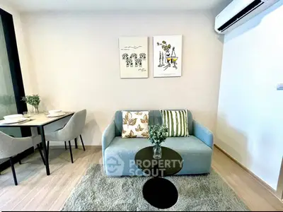 Modern living room with cozy sofa, dining area, and air conditioning in stylish apartment.