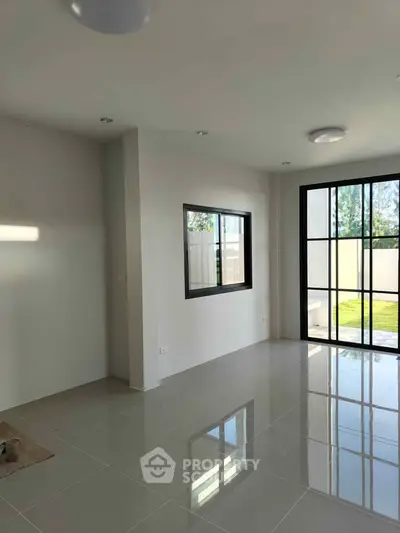 Spacious modern living room with large windows and garden view