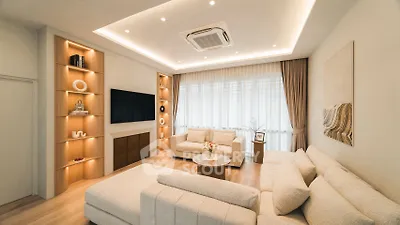 Luxurious modern living room with elegant lighting and plush seating, perfect for relaxation and entertainment.