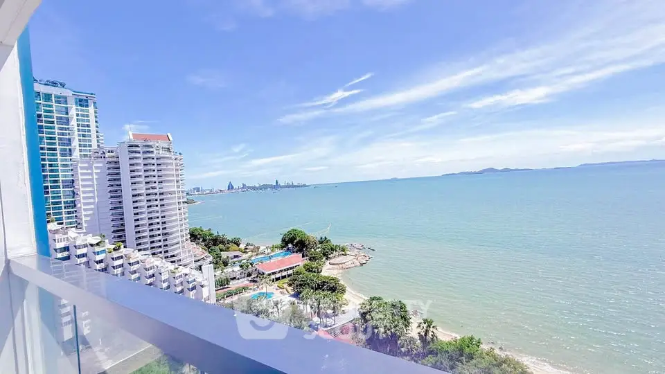 Stunning ocean view from high-rise balcony overlooking city skyline and beach.