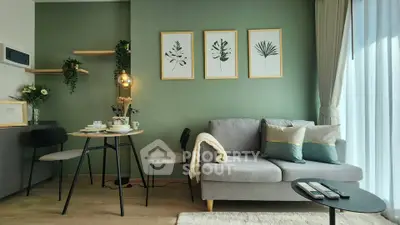 Modern living room with stylish decor and natural light, featuring a cozy sofa and elegant wall art.