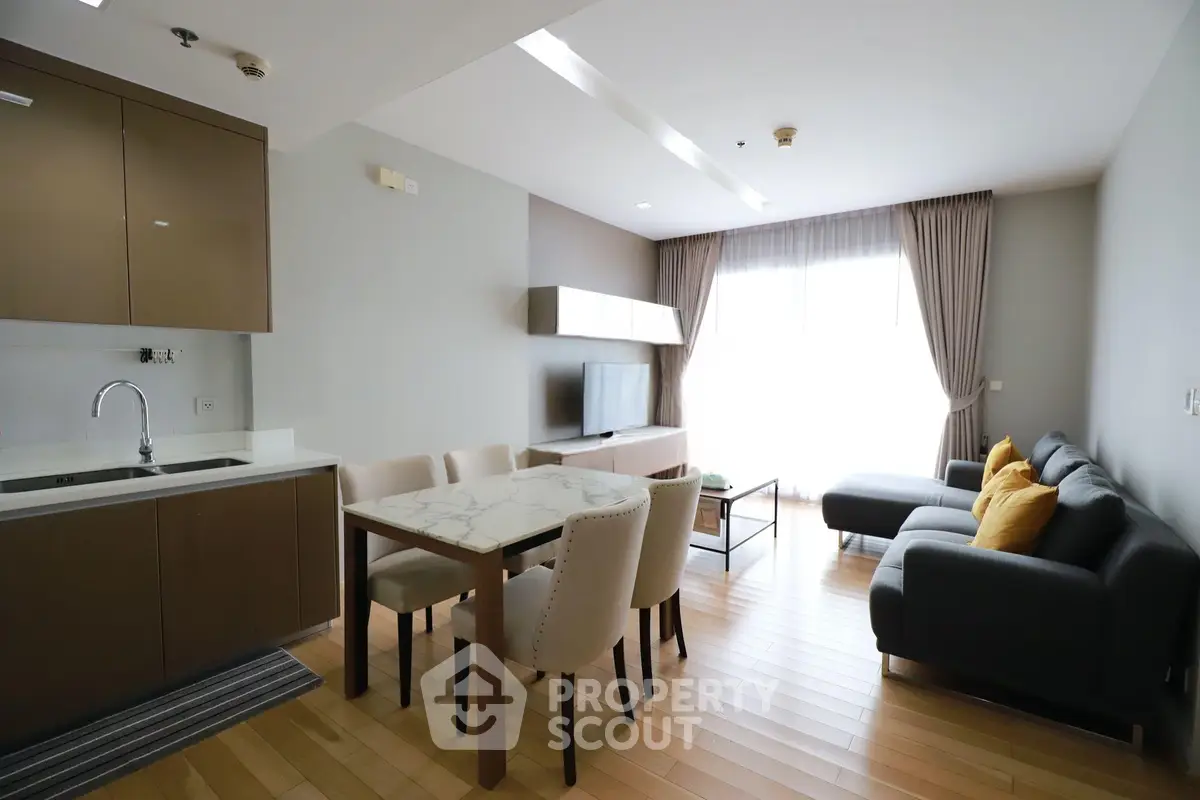 Modern living room with open kitchen and stylish furniture in a bright apartment