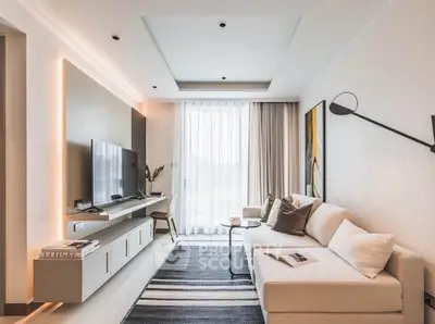 Modern living room with sleek design, featuring a cozy sofa, wall-mounted TV, and elegant decor.