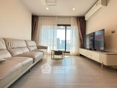 Modern living room with sleek furniture and city view from large windows.