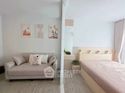 Modern studio apartment with cozy living area and stylish bedroom decor.