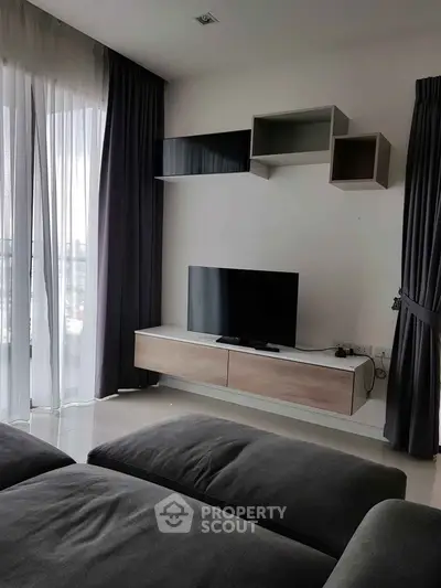 Modern living room with sleek TV setup and stylish shelving
