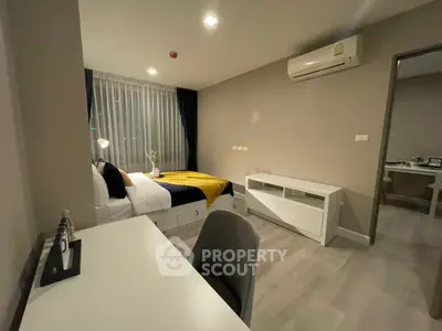 Modern bedroom with stylish decor and air conditioning in a cozy apartment.