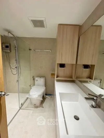 Modern bathroom with glass shower and sleek fixtures