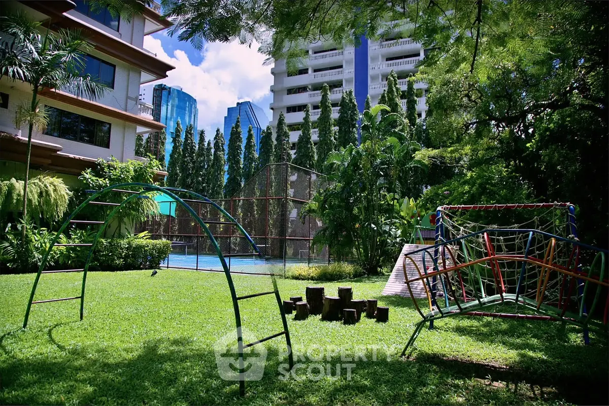 Lush garden with playground and pool in urban residential complex