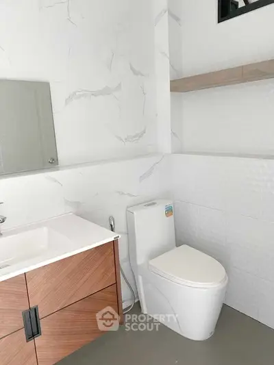 Modern bathroom with sleek fixtures and elegant marble accents.