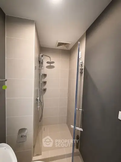 Modern bathroom with sleek shower design and neutral tiles