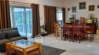 Spacious living room with elegant dining area and large windows for natural light.