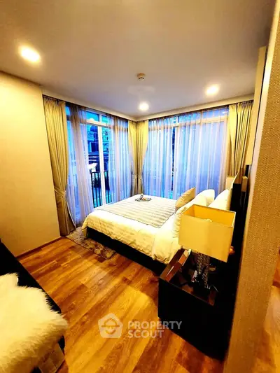Luxurious bedroom with large windows and elegant decor in modern apartment
