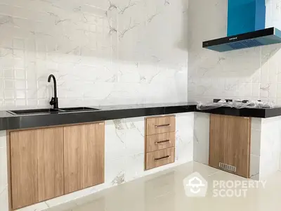 Sleek modern kitchen with marble-like tiles, wooden cabinets, and state-of-the-art appliances, perfect for culinary enthusiasts.