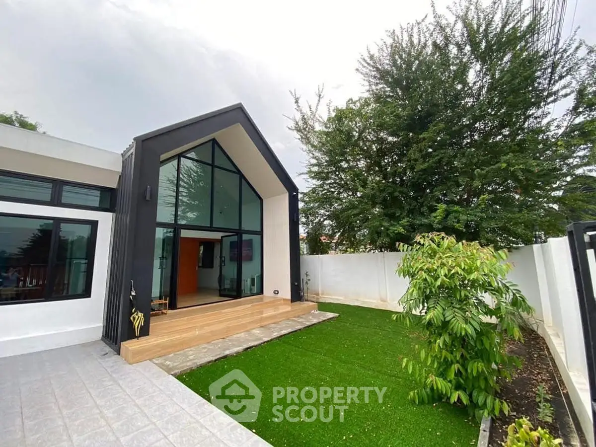 Modern single-story home with sleek design and lush green garden
