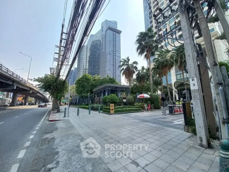 Modern urban street view with high-rise buildings and lush greenery