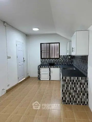 Modern kitchen with stylish backsplash and ample counter space in a compact layout.