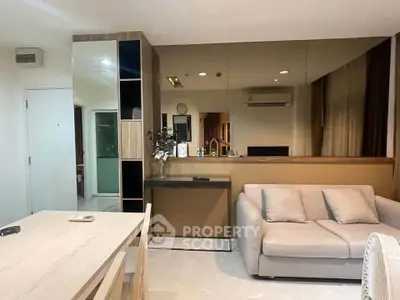 Modern living room with sleek furniture and mirrored wall in stylish apartment