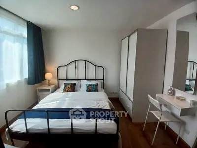 Cozy bedroom with modern furnishings and ample natural light