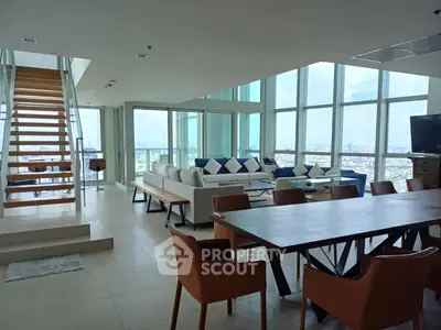 Luxurious modern living room with panoramic city views and elegant furnishings.