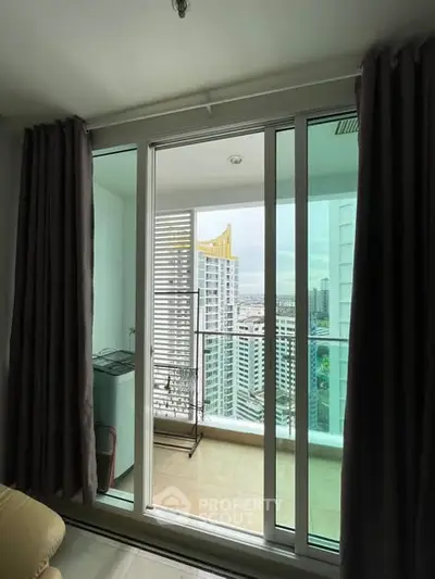 Modern apartment balcony with city view and sliding glass doors