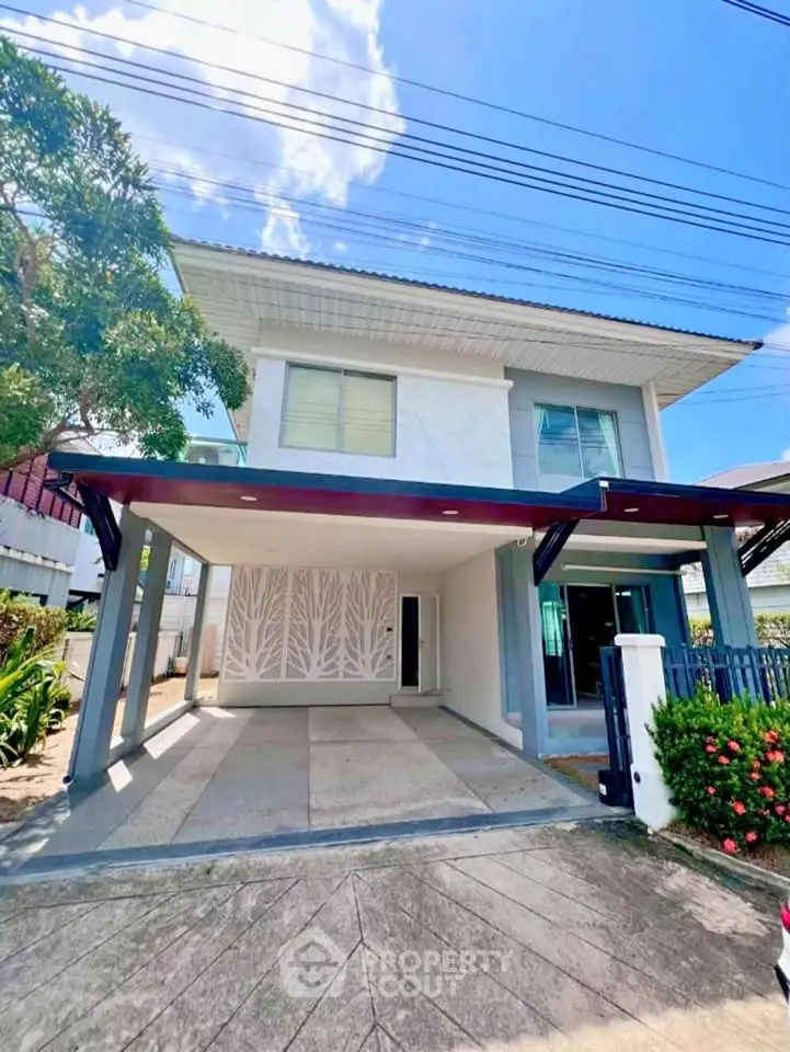 Modern two-story house with spacious driveway and contemporary design.