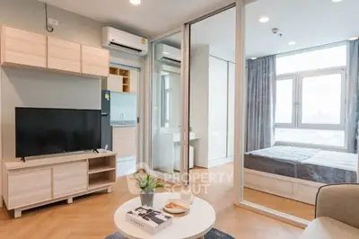 Modern apartment interior with open living room and bedroom, featuring stylish decor and natural light.