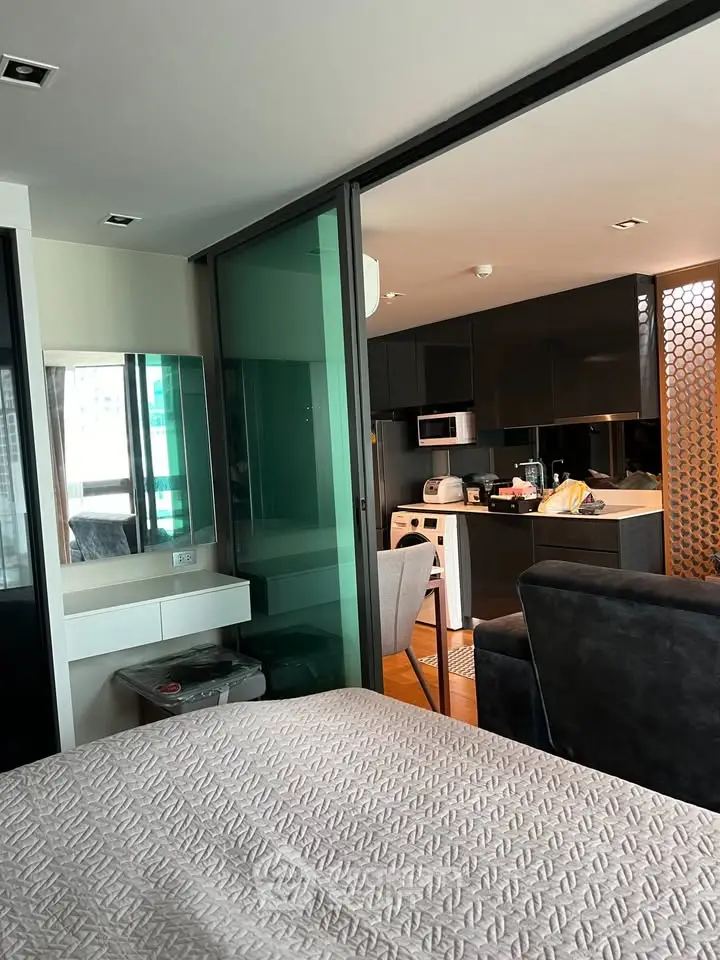 Modern open-layout apartment with sleek kitchen and cozy living area, perfect for urban living.