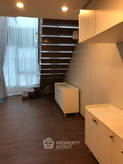 Modern duplex interior with stylish staircase and ample natural light