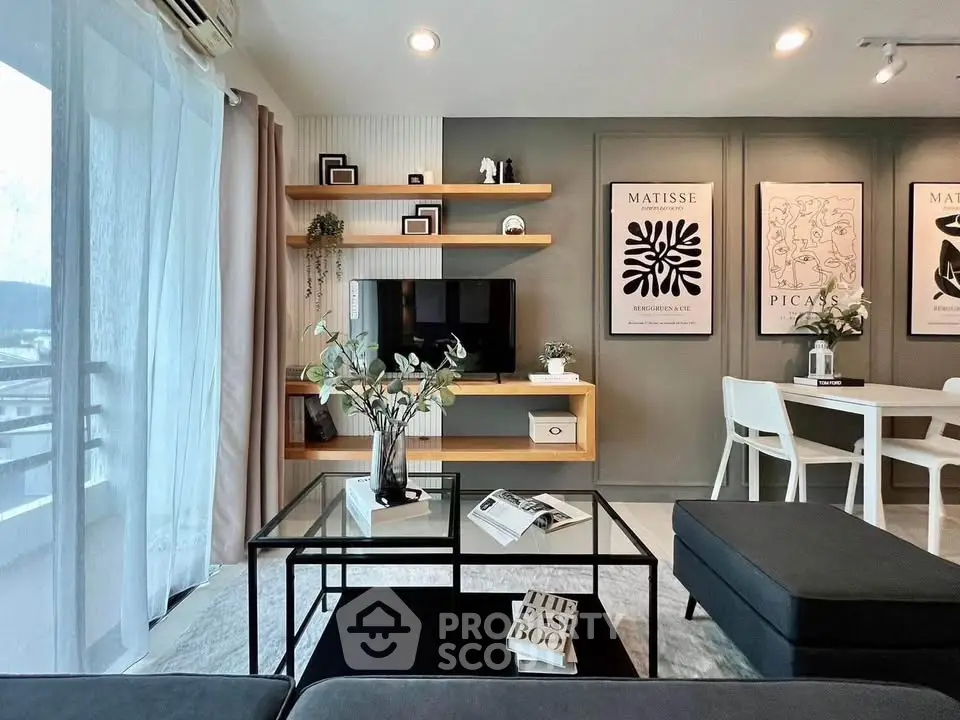 Modern living room with stylish decor and open layout, featuring elegant furniture and art pieces.