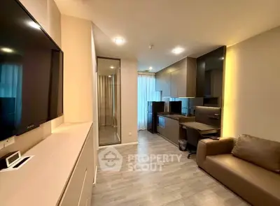 Modern open-layout living room with sleek kitchen and cozy seating area, perfect for urban living.