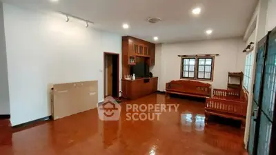 Spacious living room with wooden floors and traditional furniture