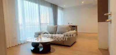 Spacious modern living room with elegant decor and large windows for natural light.