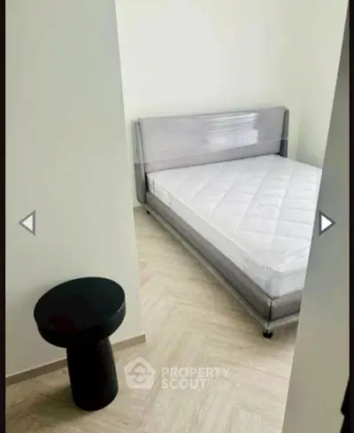 Modern minimalist bedroom with sleek bed and stylish side table