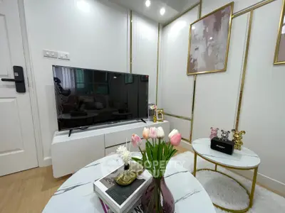 Stylish living room with modern decor and flat-screen TV, perfect for relaxation.