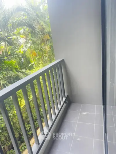 Charming balcony with lush greenery view, perfect for relaxation and enjoying nature.