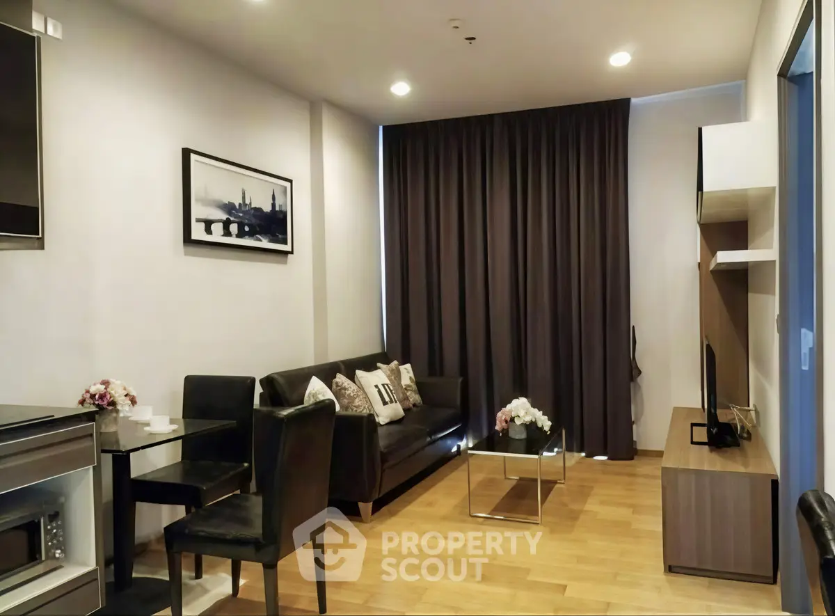 Modern living room with sleek furniture and elegant decor in a cozy apartment setting.