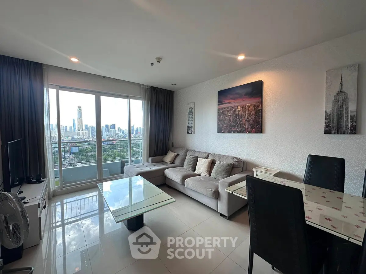 Spacious living room with city view, modern furniture, and elegant decor in a high-rise apartment.