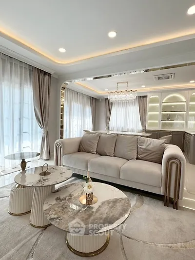 Luxurious living room with elegant sofa, marble tables, and ambient lighting in modern apartment.