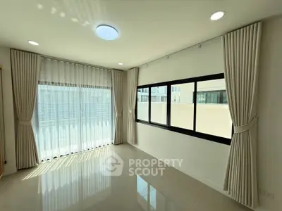 Bright and spacious corner unit with large windows and elegant curtains, perfect for natural light lovers.