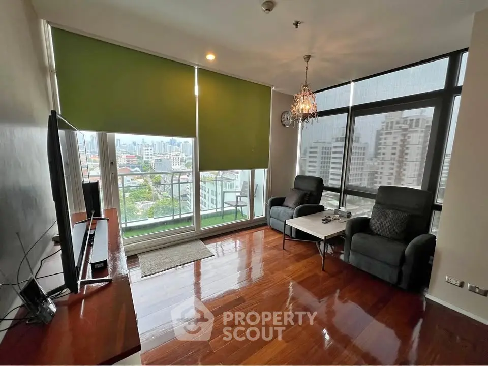 Spacious living room with city view and modern decor in high-rise apartment