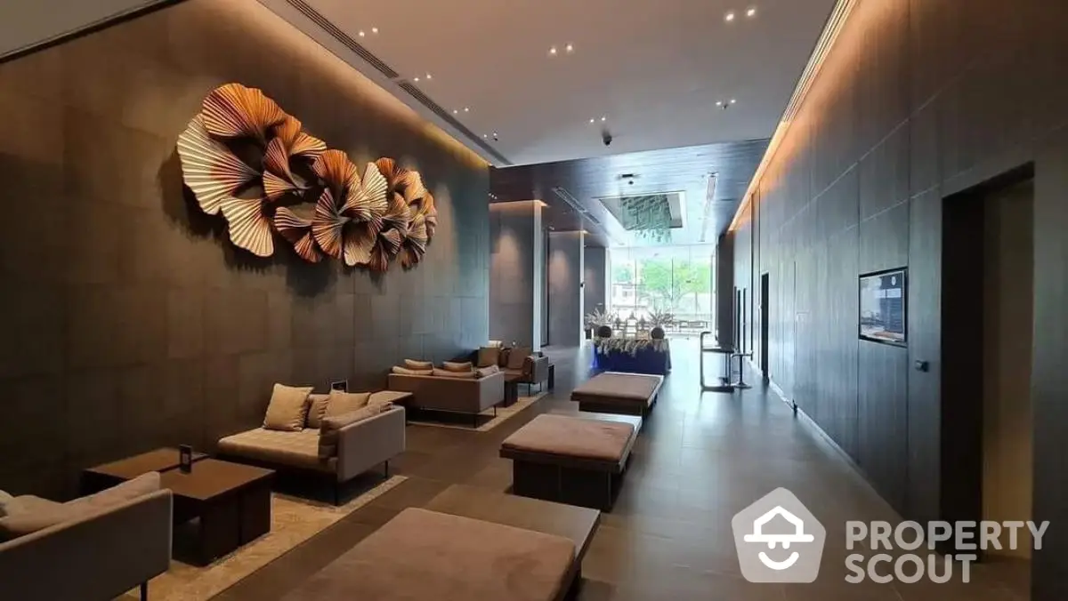 Luxurious modern lobby with artistic wall decor and plush seating in upscale building