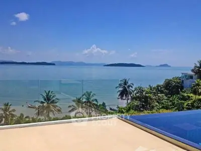 Stunning ocean view from luxury property with infinity pool and tropical landscape.