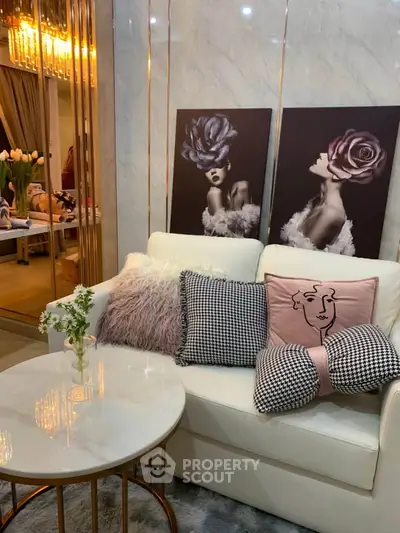 Stylish living room with modern decor, plush cushions, and elegant wall art creating a cozy ambiance.