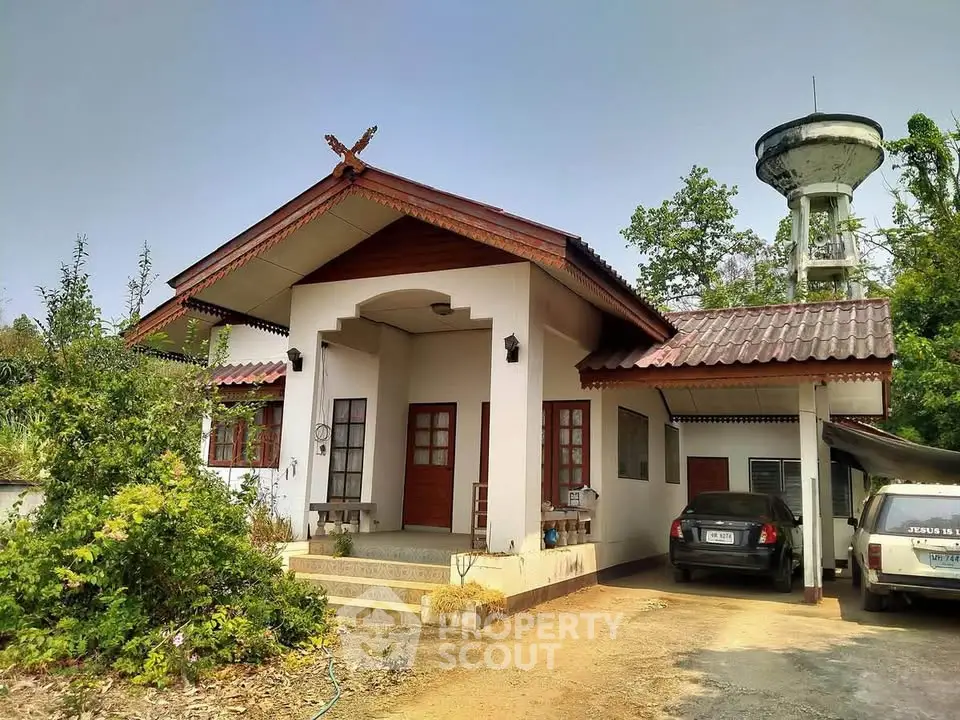 Charming single-story house with carport and lush greenery, perfect for serene living.