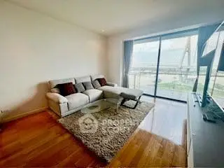 Spacious living room with modern decor and stunning balcony view