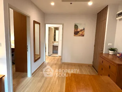 Spacious bedroom with wooden flooring and modern decor