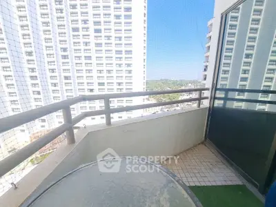 Spacious balcony with city view in modern high-rise apartment
