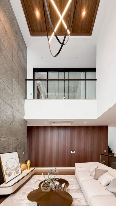 Luxurious modern living room with high ceiling and elegant chandelier