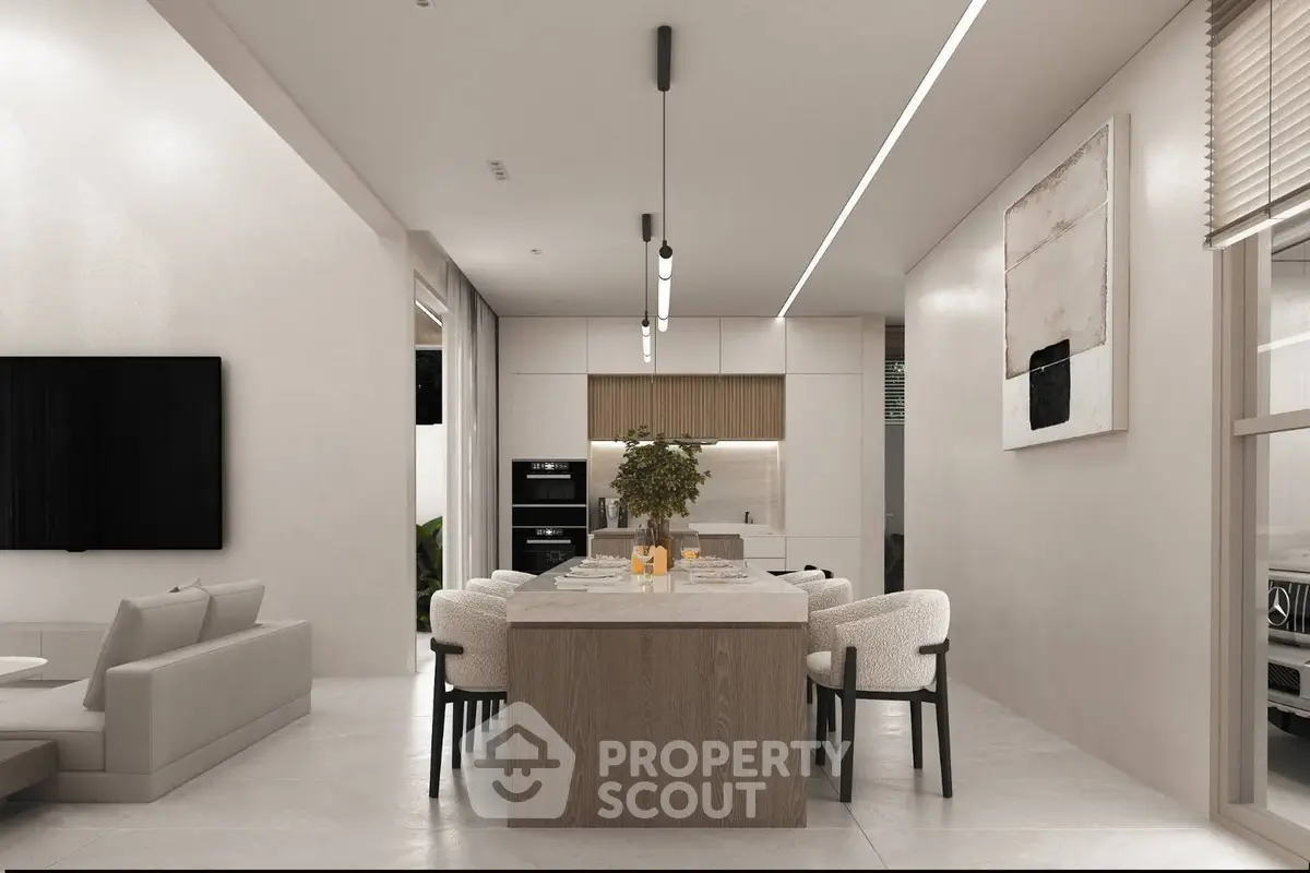 Modern open-plan kitchen and dining area with sleek design and neutral tones.